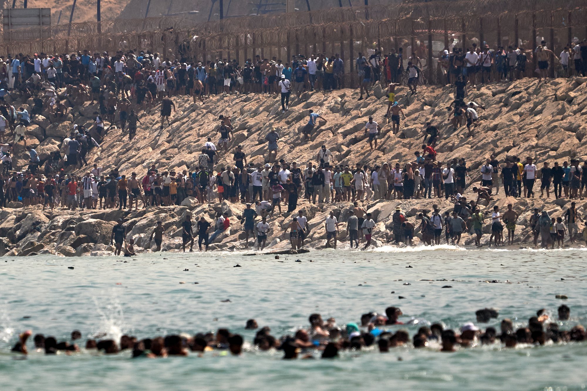 Thousands of migrants breach Spain's Ceuta border amid chaotic scenes