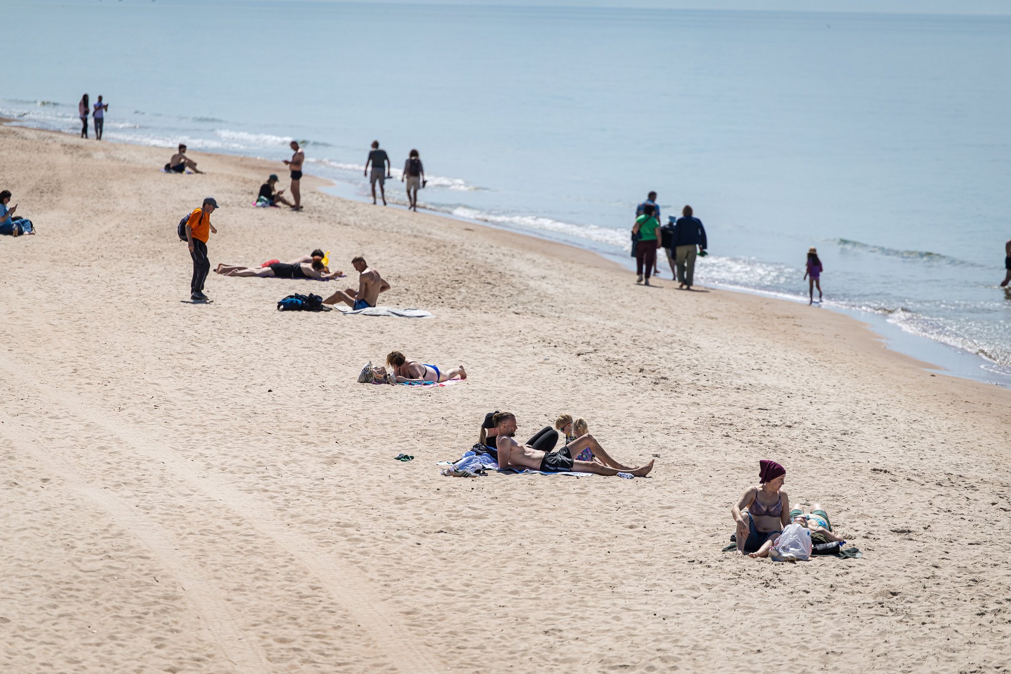 First Summer Day in Palanga: Some Hide in Jackets, Others Sunbathe on the Beach