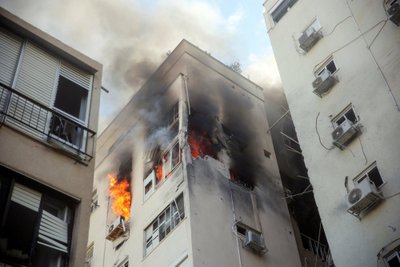 A building is ablaze following rocket attacks from the Gaza Strip, in Tel Aviv, Israel October 7, 2023. REUTERS/Itai Ron